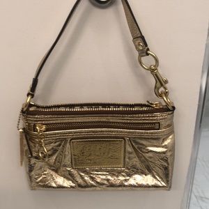 Coach clutch with a strap